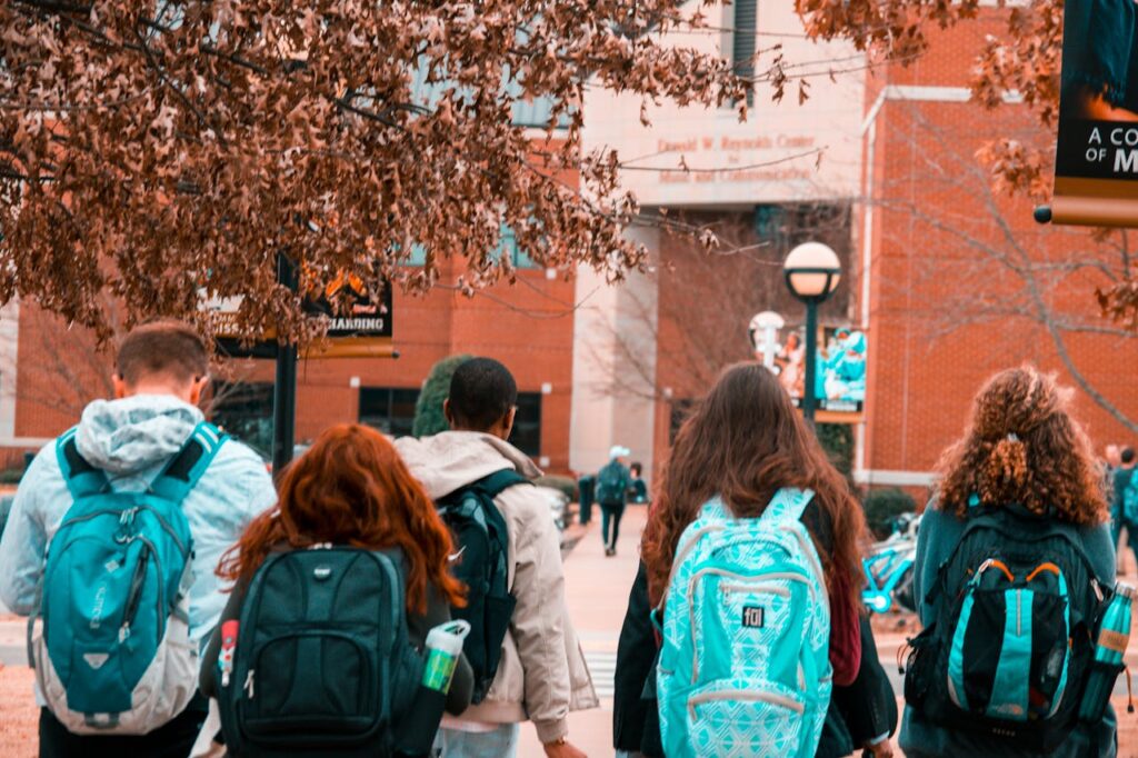 Crafting Captivating Headlines: Your awesome post title goes here A group of college students with backpacks walking together outdoors on campus.