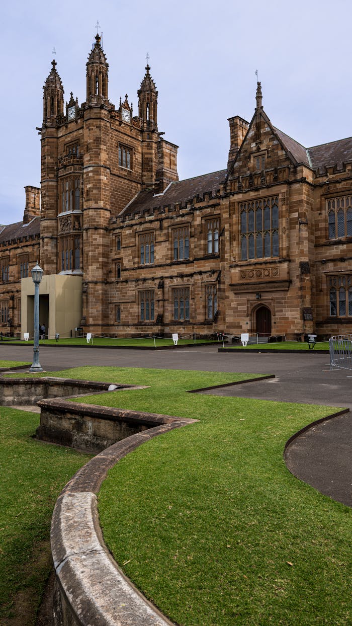 services-04 Stunning view of historic sandstone buildings at the University of Sydney, highlighting Gothic Revival architecture.