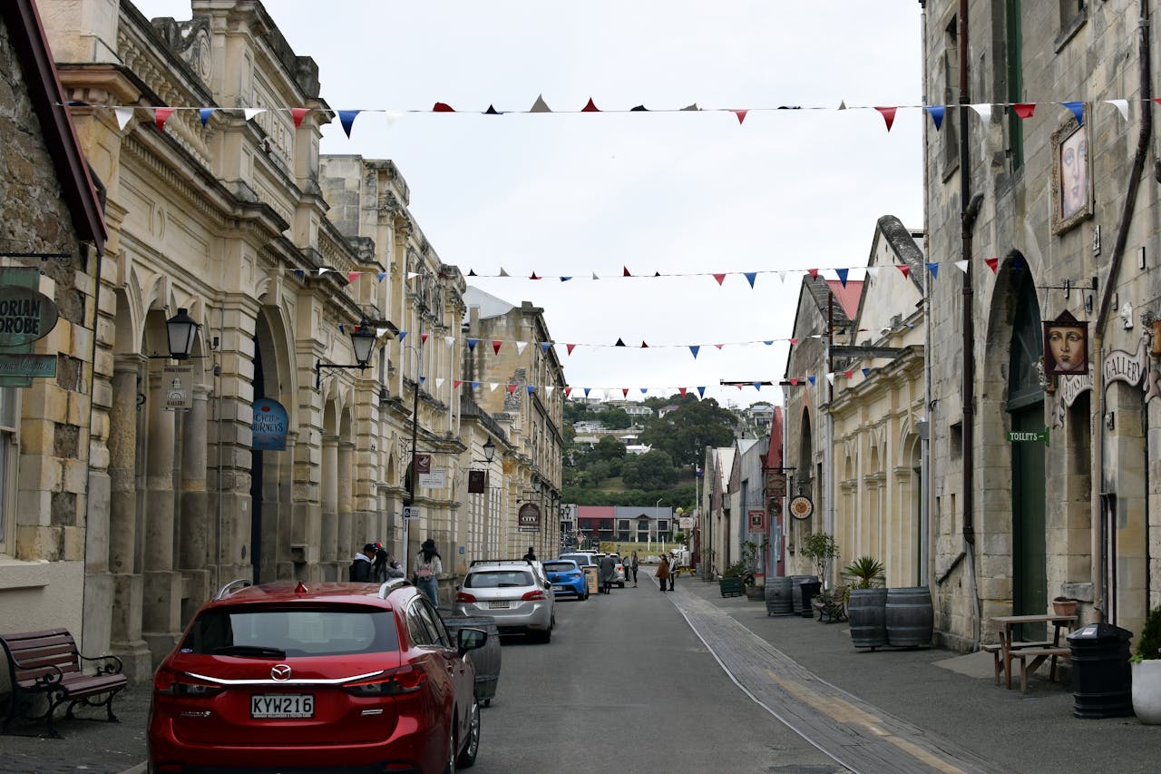 Home Charming view of a historic street in Oamaru, New Zealand, featuring architectural charm and bunting decoration.