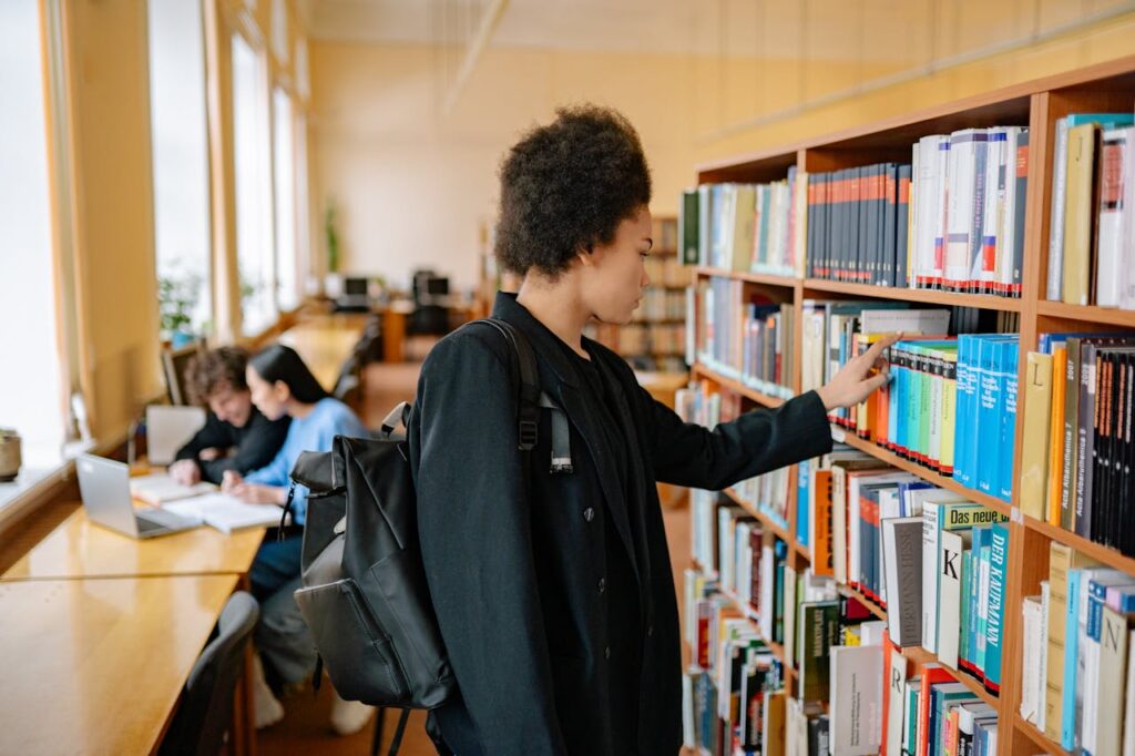 The Art of Drawing Readers In: Your attractive post title goes here Focused student with a backpack selecting a book in a university library.